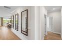 Bright hallway with decorative mirrors and hardwood flooring at 244 Nesta Grove, Locust Grove, GA 30248