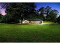 Exterior shot of the home with a large lawn and mature trees at 3355 Wesley Chapel Rd, Decatur, GA 30034