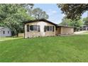 The home has a charming exterior with a well-manicured lawn and mature trees at 3355 Wesley Chapel Rd, Decatur, GA 30034