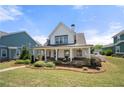 Charming two-story home with a welcoming front porch and beautifully landscaped front yard at 4044 Andover Cir, Mcdonough, GA 30252