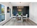 Contemporary dining room with black accent wall and luxury vinyl plank flooring at 139 Thunder Ridge Ln, Acworth, GA 30101