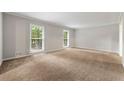 Bright, spacious living room featuring neutral paint and plush carpeting, illuminated by natural light at 1415 Hialeah Ct, Marietta, GA 30062