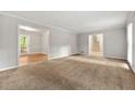Open living room with carpet, natural light, and views to the dining area and staircase at 1415 Hialeah Ct, Marietta, GA 30062