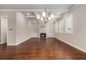Spacious living room with hardwood floors, a fireplace, built-in shelves and coffered ceiling at 3139 Hilltop Drive, Marietta, GA 30066