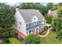 Expansive home with a sprawling lawn surrounded by lush trees at 6219 Creekstone Path, Cumming, GA 30041