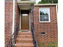 Inviting brick entryway with stairs and a classic front door at 1753 Cahoon Sw St, Atlanta, GA 30310