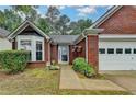 Charming one story brick home with manicured lawn and attached two car garage at 1965 Sterling Creek Ct, Snellville, GA 30078