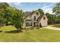 Charming two-story home with a well-maintained lawn, two car garage and mature landscaping at 4001 English Valley Dr, Ellenwood, GA 30294