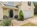 Inviting front porch with seating, a landscaped yard and an attached two-car garage at 4001 English Valley Dr, Ellenwood, GA 30294
