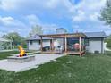 Backyard features a stone firepit, wooden pergola, and covered grilling station, perfect for outdoor entertaining at 464 Mason Dr, Canton, GA 30115