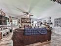 Inviting living room features hardwood floors, stone fireplace, ceiling fan and unique decor at 464 Mason Dr, Canton, GA 30115