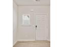 Bright entryway with hardwood floors, a white front door and small window that lets in plenty of natural light at 5095 Lower Elm St, Atlanta, GA 30349