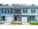These charming townhomes come with attached garages and pleasing light blue and grey color schemes at 5095 Lower Elm St, Atlanta, GA 30349