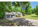 View of home featuring long driveway leading up to a white-sided ranch home with an attached two-car garage at 545 Willow Creek Dr, Temple, GA 30179