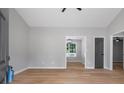 Open-concept living space with wood flooring, neutral paint, high ceilings, and great natural light at 545 Willow Creek Dr, Temple, GA 30179