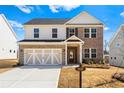 Beautiful two-story home with brick and siding featuring a two-car garage and a well-kept front yard at 1619 Tide Mill Road, Cumming, GA 30040