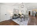 Bright living room with hardwood floors, neutral decor, high ceiling, and stainless steel kitchen appliances at 2133 Trailwood Rd, Decatur, GA 30032