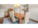 Formal dining room with hardwood floors, wainscoting, a wooden table with seating for six, and an elegant chandelier at 2700 Vinings Orchard Cir, Atlanta, GA 30339