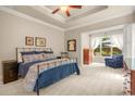 Spacious main bedroom features a trey ceiling, neutral colors, and a sitting area with views of the private backyard at 2700 Vinings Orchard Cir, Atlanta, GA 30339