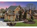 Elegant brick home with manicured lawn, mature trees and a side-entry driveway at 2740 Heritage Bend Sw Ct, Grayson, GA 30017