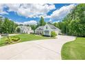 Stunning white farmhouse-style home featuring a long driveway and lush landscaping at 124 White Oak Trl, Cumming, GA 30028