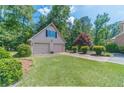 Two-car detached garage with green lawn and mature landscaping at 3510 Eagle Landing Dr, Snellville, GA 30039