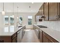 Modern kitchen with large island, stainless steel appliances, and bright white countertops at 784 Keystone Dr, Woodstock, GA 30188
