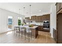 Bright kitchen with island, stainless steel appliances, sleek cabinets, and hardwood floors at 784 Keystone Dr, Woodstock, GA 30188