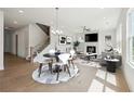 Open-concept living room with hardwood floors, fireplace, and plenty of natural light at 784 Keystone Dr, Woodstock, GA 30188