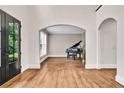 Bright and airy foyer featuring hardwood floors and arched doorways leading to other rooms at 1231 Ellington Ct, Cumming, GA 30041