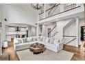 Spacious living room with a soaring ceiling, grand staircase, and modern chandelier at 1231 Ellington Ct, Cumming, GA 30041
