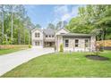 Charming two-story home featuring stone accents, three-car garage, and a well-manicured lawn at 1273 Grayson Pkwy, Grayson, GA 30017