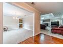 Inviting living room with hardwood floors, a brick fireplace, and access to the adjacent dining room at 1419 Gates Mill Walk, Lawrenceville, GA 30045