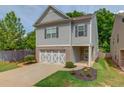 Charming two-story home with a well-manicured lawn and a welcoming front entrance and a two car garage at 2275 Black Pebble Cir, Buford, GA 30519