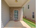 Covered patio with brick siding and a door into the home at 2275 Black Pebble Cir, Buford, GA 30519