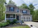 Attractive two-story home with a welcoming front porch and attached two-car garage at 3420 Griffin Way, Cumming, GA 30040