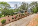 Charming exterior with a sloped front yard, fresh mulch and plants, and inviting front stairs at 525 Rosemont Dr, Decatur, GA 30032