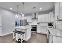 Modern kitchen featuring stainless steel appliances, a center island with seating, and bright white cabinetry at 6240 Vista Crossing Way, Cumming, GA 30028