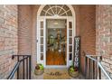 Warm entryway with hardwood floors, a welcoming mat, and decorative plants at 1444 Merrifield Ln, Marietta, GA 30062