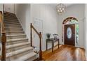 Elegant foyer with hardwood floors, a staircase, and an arched doorway at 1444 Merrifield Ln, Marietta, GA 30062