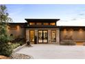 Contemporary home featuring a grand entrance, manicured landscaping, and a stone exterior at 2746 Emerald Dr, Jonesboro, GA 30236