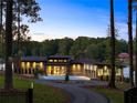 Secluded modern home, nestled among mature trees, features a private driveway and lake access at 2746 Emerald Dr, Jonesboro, GA 30236
