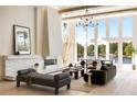 Bright and airy living room with soaring ceilings, a modern fireplace, and beautiful lake views at 2746 Emerald Dr, Jonesboro, GA 30236