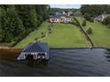 Breathtaking aerial view showcasing the property's expansive lawn, private dock, and serene waterfront location at 3085 Lake Park Dr, Jonesboro, GA 30236