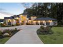 Stunning exterior elevation of this luxurious home with a grand entrance and meticulously landscaped front yard at 3085 Lake Park Dr, Jonesboro, GA 30236