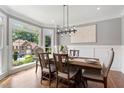 Bright dining room featuring large windows, hardwood floors, and stylish furnishings for elegant meals at 2510 Wood Creek Ct, Dacula, GA 30019