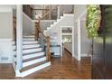 Elegant foyer with hardwood floors, a staircase with iron railings, and a view into the living room at 2510 Wood Creek Ct, Dacula, GA 30019