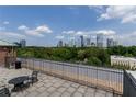 Rooftop patio with wrought iron furniture and fence showing expansive city views at 3235 Roswell Ne Rd # 514, Atlanta, GA 30305