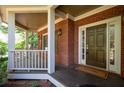 Charming front porch with brick accents, white columns, and a warm welcome mat at 4711 Oakleigh Manor Dr, Powder Springs, GA 30127