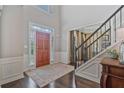 Elegant entryway with hardwood floors, high ceilings, and staircase with iron railing at 8045 Depford Way, Cumming, GA 30041